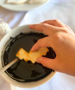 dip bat cookies in icing simple Halloween decorated cookie