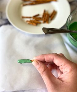 dip pretzels in melted green chocolate to make stems for easy Halloween Oreo balls