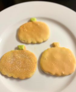 3 different versions of simple decorated pumpkin cookies