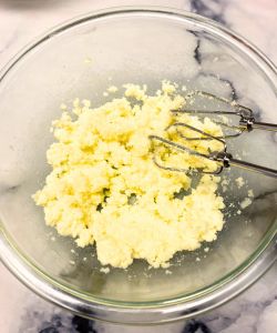 cream butter and sugar for banana muffins filled with strawberry jam