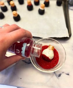 decorate christmas ornament oreo balls with sprinkles