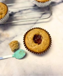 spoon in jam for banana muffins filled with jam