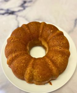 turn finished pumpkin spice cake with cream cheese filling out on a plate