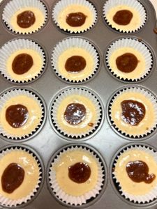 add teaspoon of cinnamon sugar filling to center of well in muffin tin