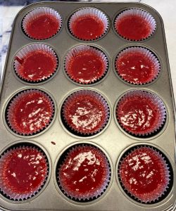 pour super easy vegan red velvet cupcake batter into liners