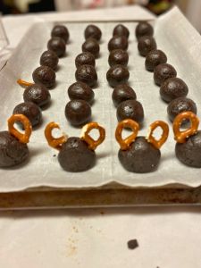 attach antlers to reindeer shaped caramel Oreo balls