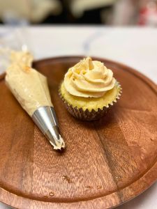 pipe frosting onto pancake cupcakes with maple frosting browned butter maple frosting