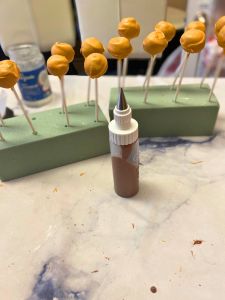 small icing bottle to drizzle chocolate salted caramel cake pops