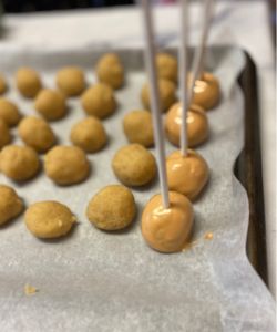 coat salted caramel apple cake pops in caramel