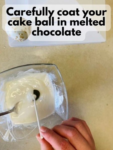 coat cake pop in melted chocolate