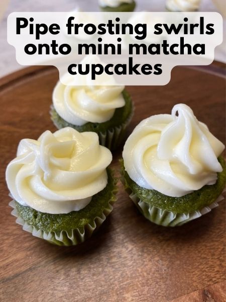 pipe frosting onto finished mini matcha cupcakes