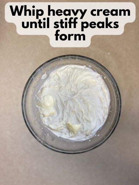 whip heavy cream until stiff peaks form