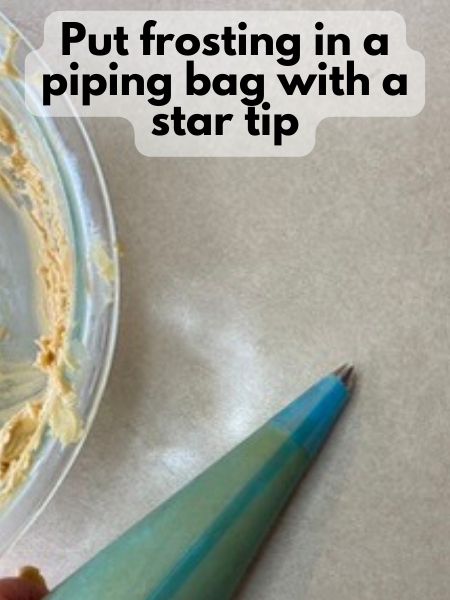 add frosting to piping bag with star tip