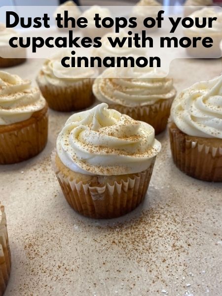 add extra cinnamon on top of frosted cupcakes