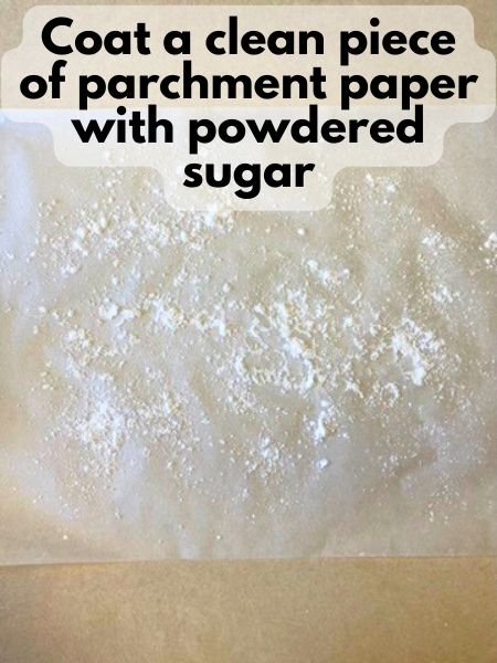 coat a clean piece of parchment paper with powdered sugar