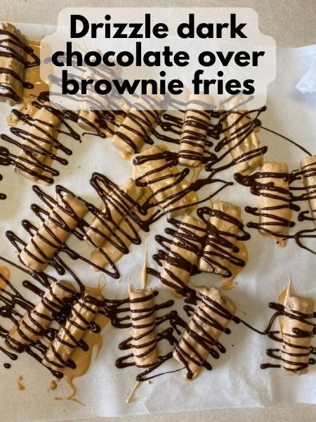 drizzle dark chocolate over salted caramel coated brownie fries for decoration