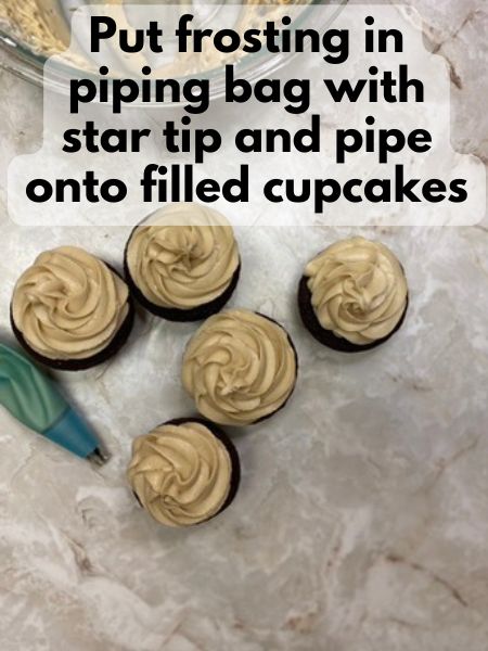 pipe frosting onto filled cupcakes