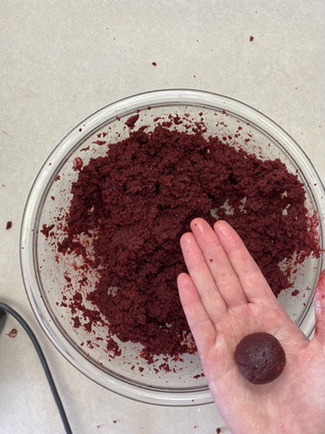 red velvet cake dough with a ball of red velvet cake