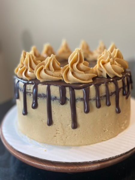 chocolate layer cake with peanut butter frosting and a chocolate ganache drizzle