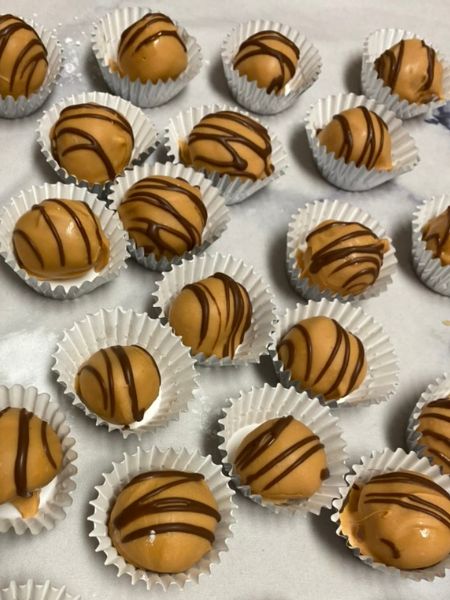 cookie butter truffles with a salted caramel coating and chocolate drizzle