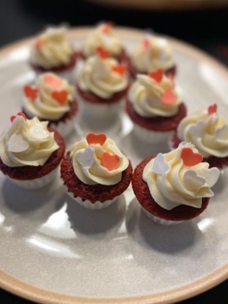 mini red velvet cupcakes with cream cheese frosting and heart sprinkles