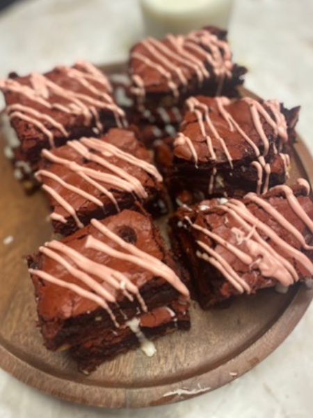 red velvet brownies decorated with a pink chocolate drizzle