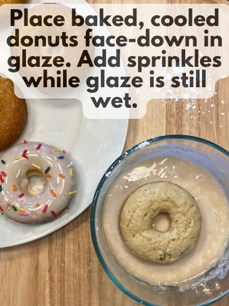 donut turned face-down in glaze while another donut sits on a plate decorated with sprinkles