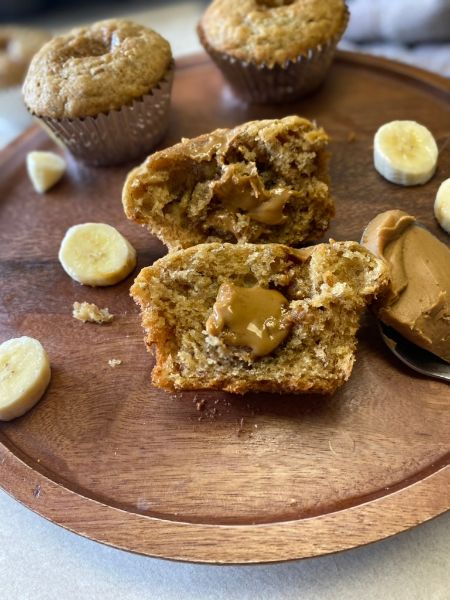 banana muffin with cookie butter filling cut in half on a plate