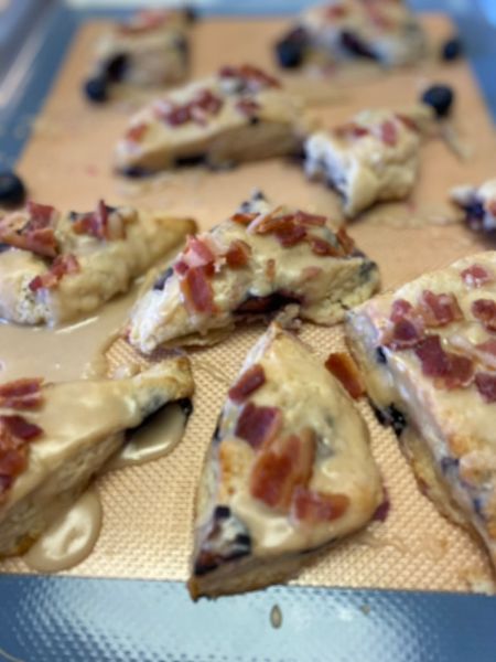 blueberry maple baking scones sitting on a baking sheet