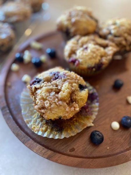 blueberry white chocolate muffins sitting on a plate