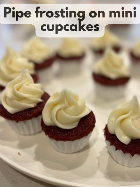 mini red velvet cupcakes with swirls of cream cheese frosting