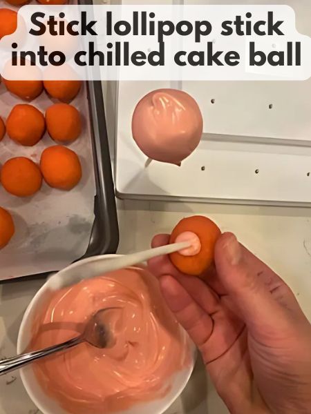 lollipop stick inserted into a strawberry bake ball