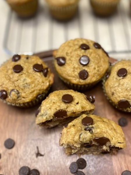 banana peanut butter chocolate chip muffins sitting on a plate