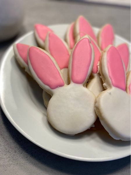 cut out cookies in the shape of bunnies and decorated like bunnies