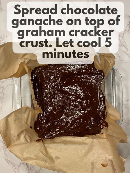 chocolate ganache spread on top of graham cracker crumbs