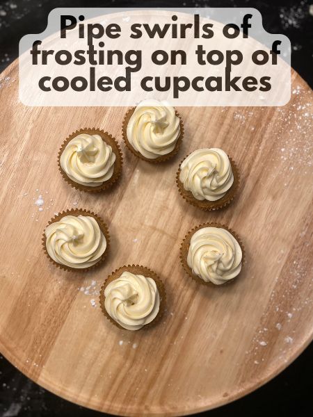 pipe swirls of frosting on top of cupcakes