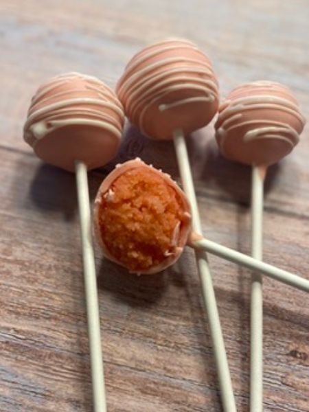 strawberry cake pops coated in pastel pink chocolate