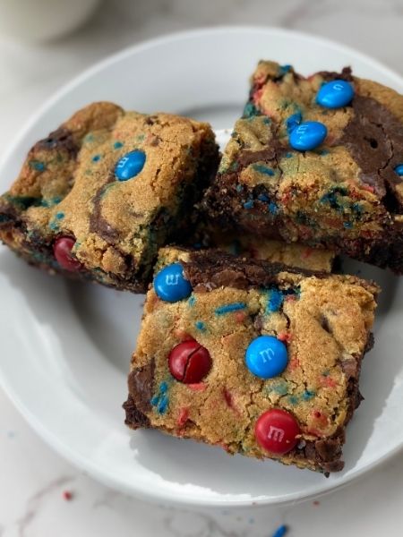 4th of July brookies with a brownie base topped with cookie dough sprinkles with red and blue M&M's and sprinkles