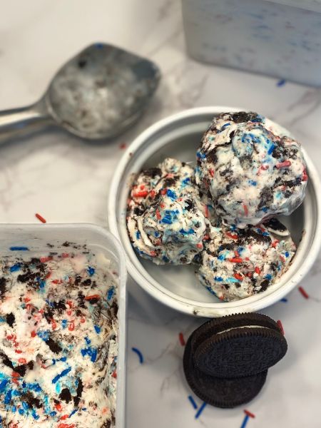 vanilla ice cream with chopped Oreos and red and blue sprinkles