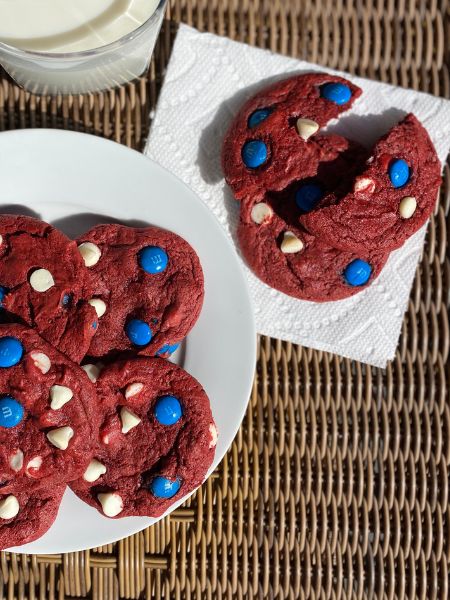 red velvet cookies with white chocolate chips and blue M&Ms