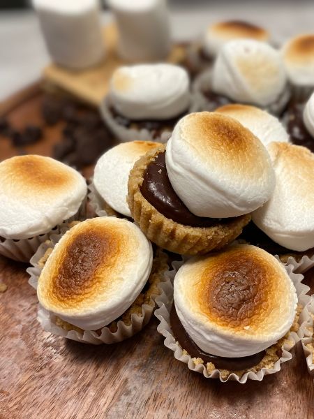mini s'mores cupcakes with a graham cracker crust, chocolate ganache filling and topped with a toasted marshmallow