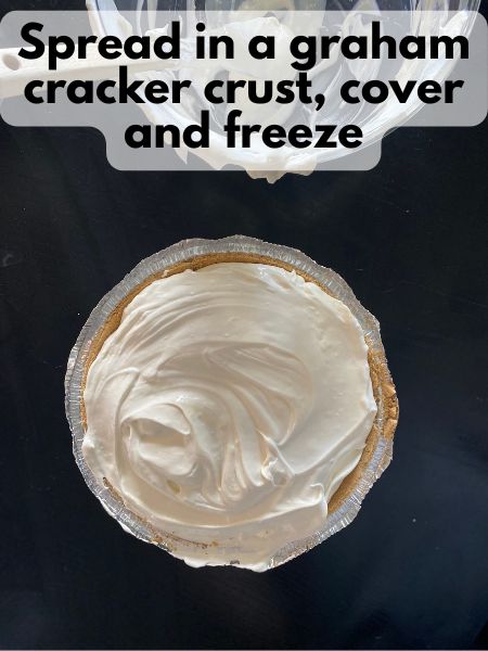 frozen lemonade pie batter spread in a graham cracker crust