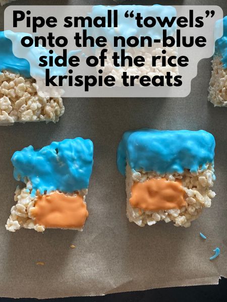 rice krispie treats with half of the rice krispie treat dipped in blue chocolate and the other half with an orange chocolate rectangle
