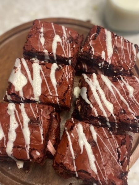 red velvet brownies drizzled with white chocolate on top