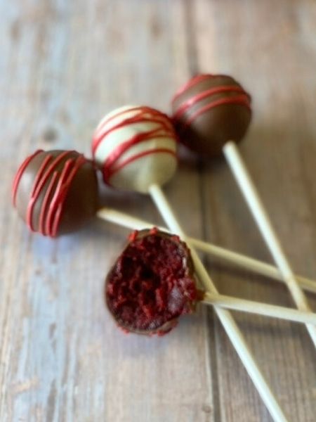 red velvet cake pops coated in white, brown and red chocolate