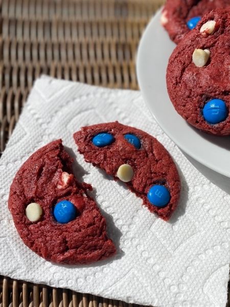 red velvet cookies with white chocolate chips and blue M&Ms