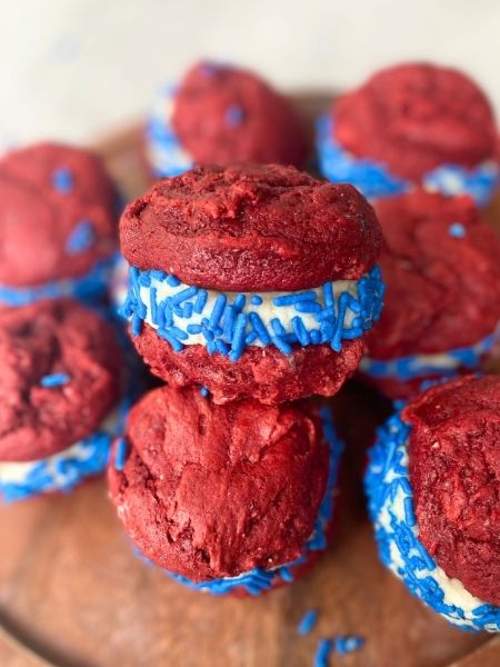 red velvet whoopie pies with creamy white filling and blue sprinkles