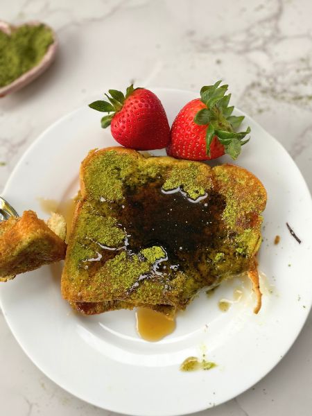 matcha french toast with maple syrup and strawberries