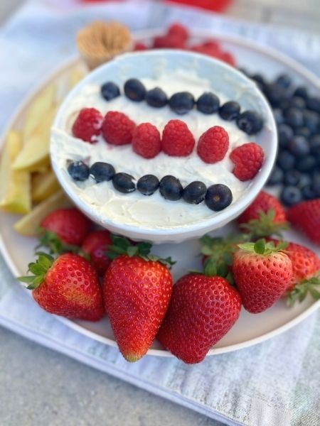 cheesecake fruit dip with red and blue berries