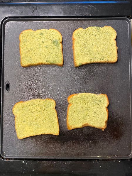 matcha french toast cooking on a griddl
